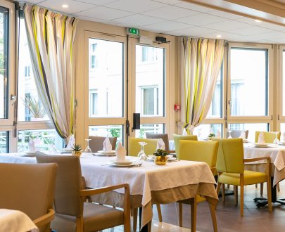 tables dressées au restaurant avec vue sur jardin